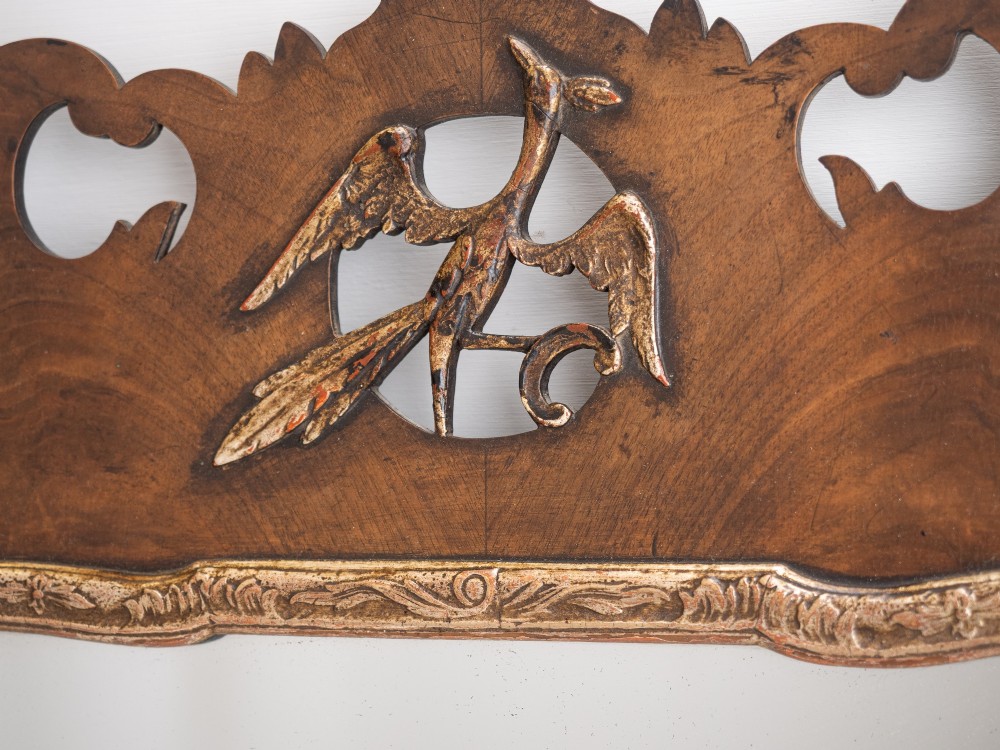A George II style walnut fretwork pier mirror featuring a carved parcel-gilt hoho bird motif on the crest and a gilded inner moulding. View VIII