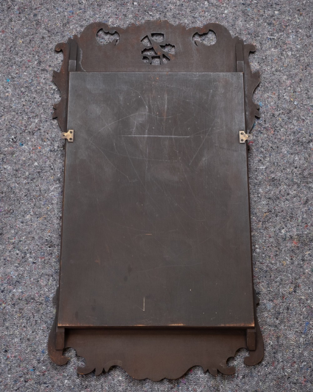 A George II style walnut fretwork pier mirror featuring a carved parcel-gilt hoho bird motif on the crest and a gilded inner moulding. View IX