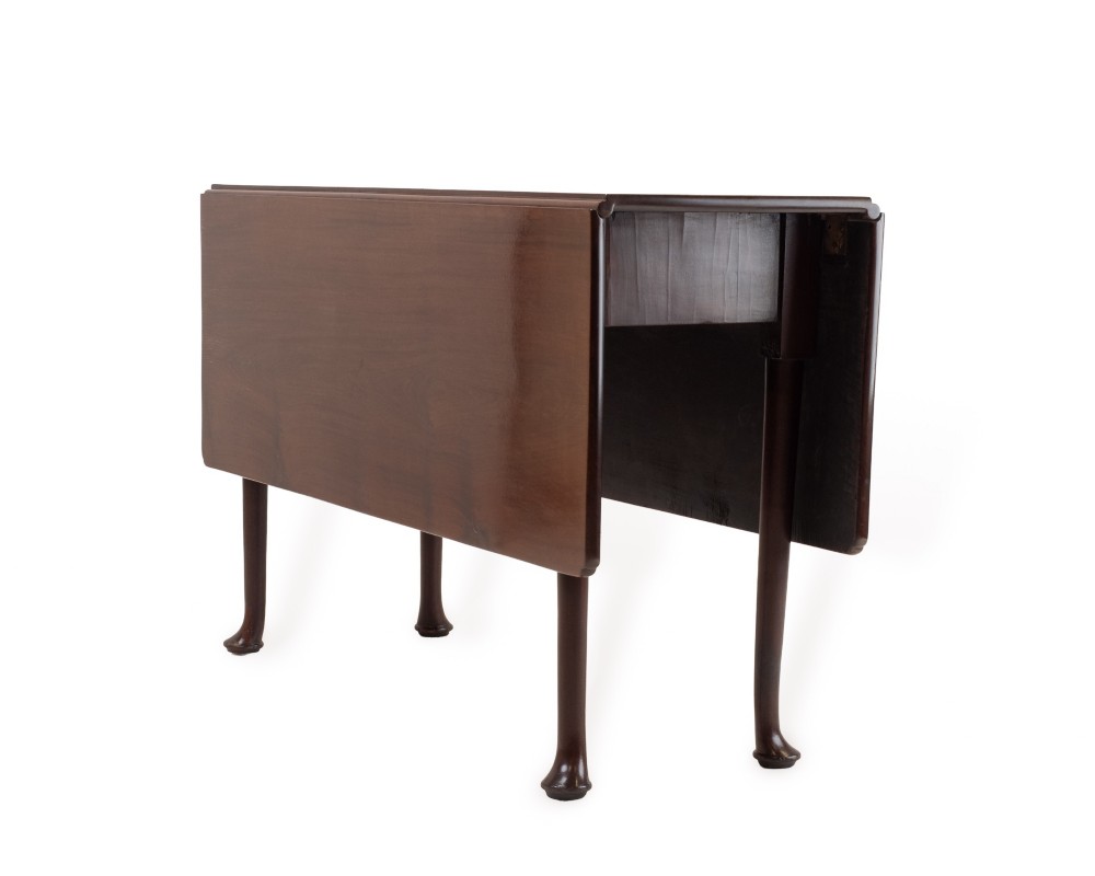 An antique dark walnut drop-leaf gateleg table shown with both extension leaves fully raised and slender turned legs. View II