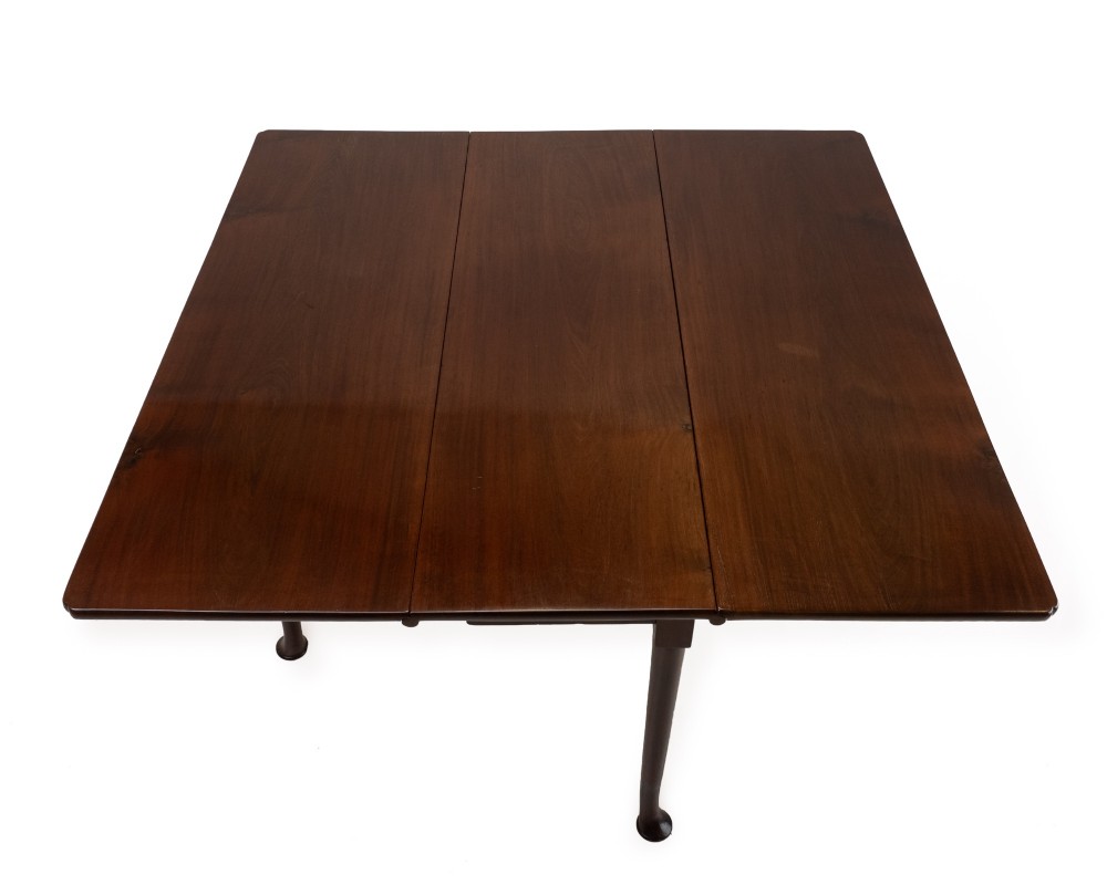 An antique dark walnut drop-leaf gateleg table shown with both extension leaves fully raised and slender turned legs. View V