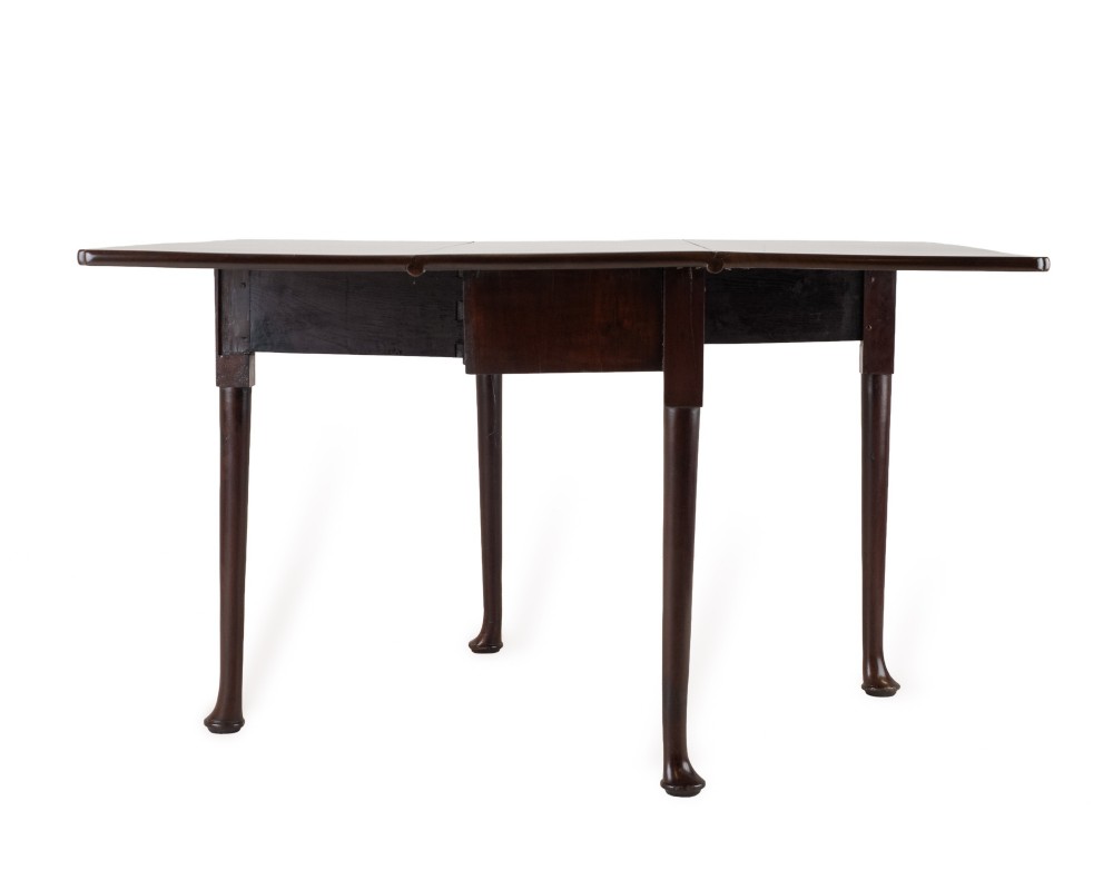 An antique dark walnut drop-leaf gateleg table shown with both extension leaves fully raised and slender turned legs. View X