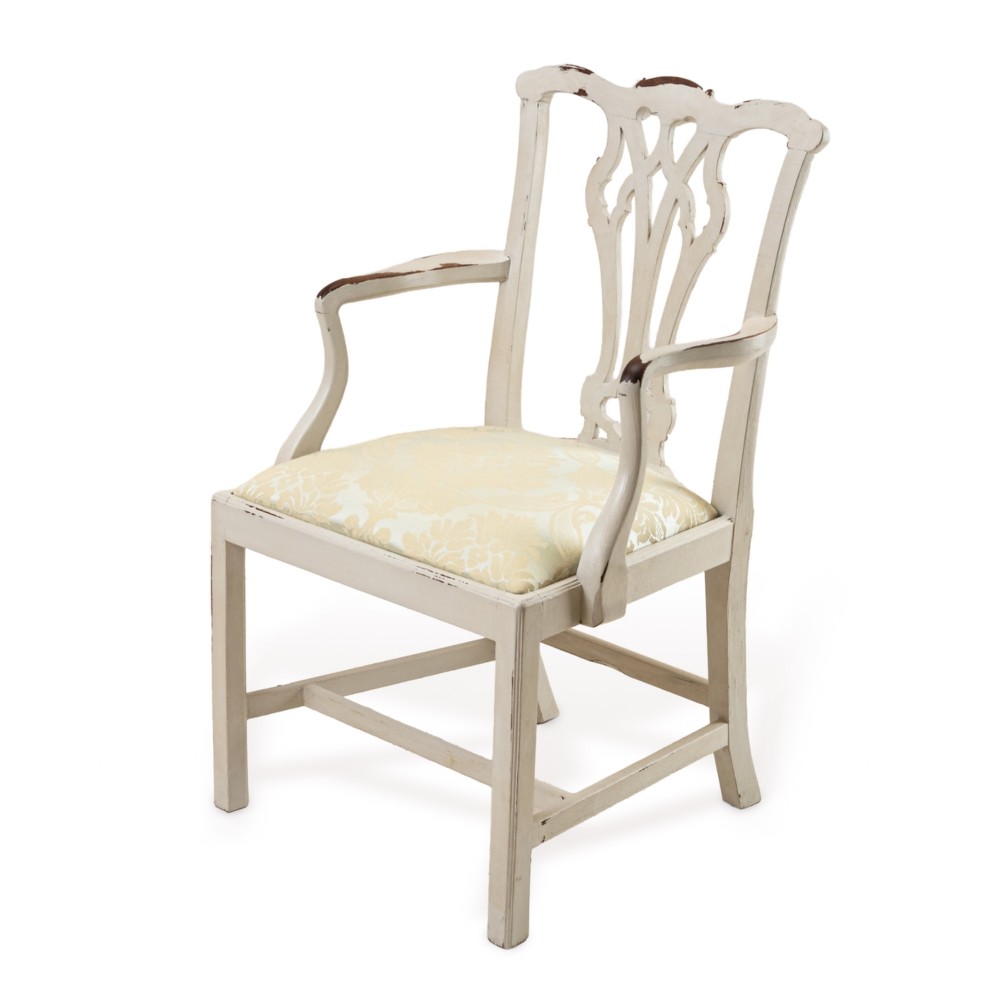 A Georgian Chippendale style armchair featuring an off-white painted finish with visible distressing, a pierced back splat, and a patterned fabric seat.