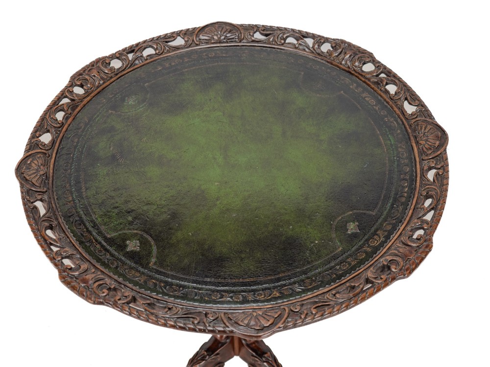 A Chippendale Revival mahogany wine table featuring a green leather top, a piecrust border, a carved central pedestal, and a carved tripod base. View II