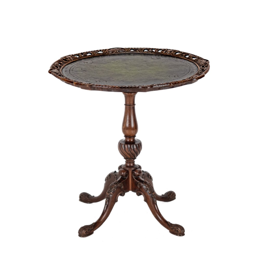 A Chippendale Revival mahogany wine table featuring a green leather top, a piecrust border, a carved central pedestal, and a carved tripod base. View III