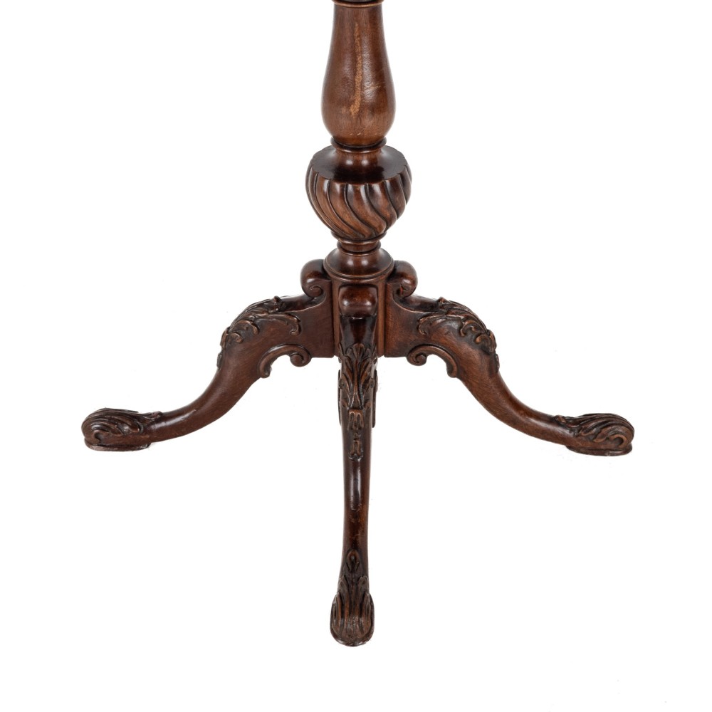 A Chippendale Revival mahogany wine table featuring a green leather top, a piecrust border, a carved central pedestal, and a carved tripod base. View VIII