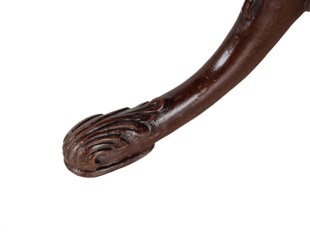 A Chippendale Revival mahogany wine table featuring a green leather top, a piecrust border, a carved central pedestal, and a carved tripod base. View IX