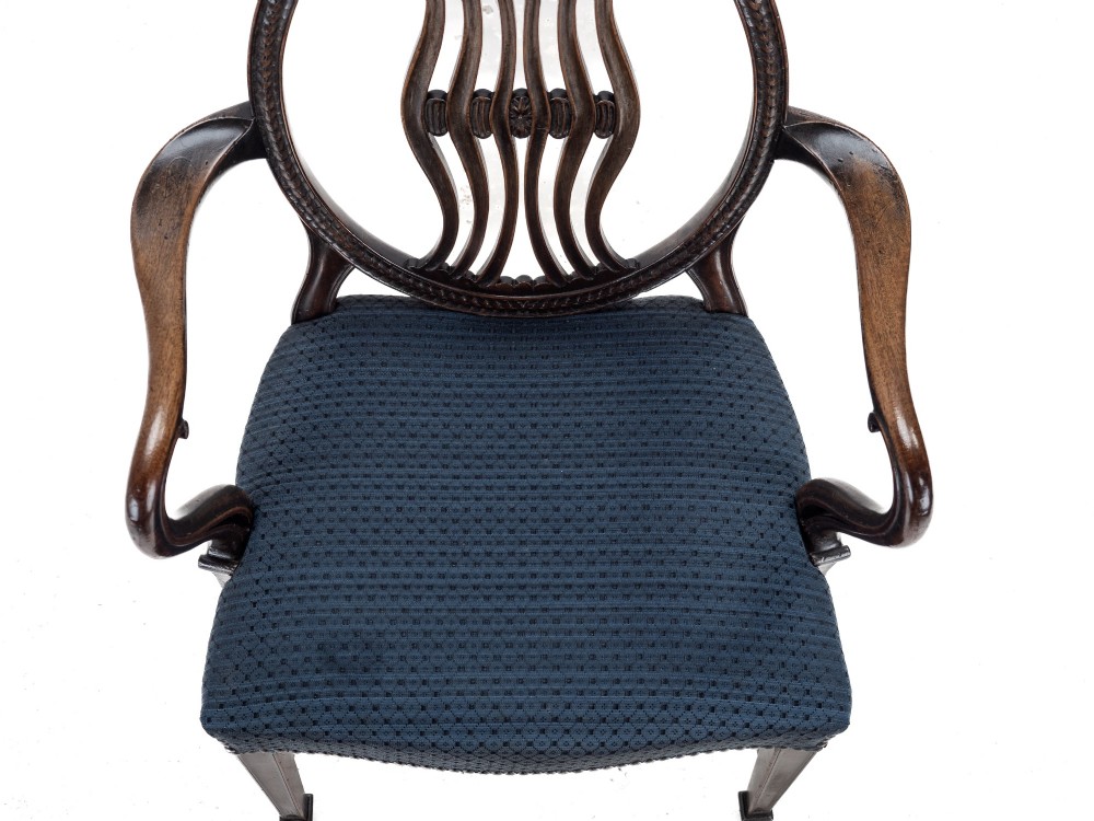 A pair of late 19th-century mahogany Hepplewhite-style carver armchairs featuring carved oval backs and navy blue upholstered seats with brass studding. View XIII