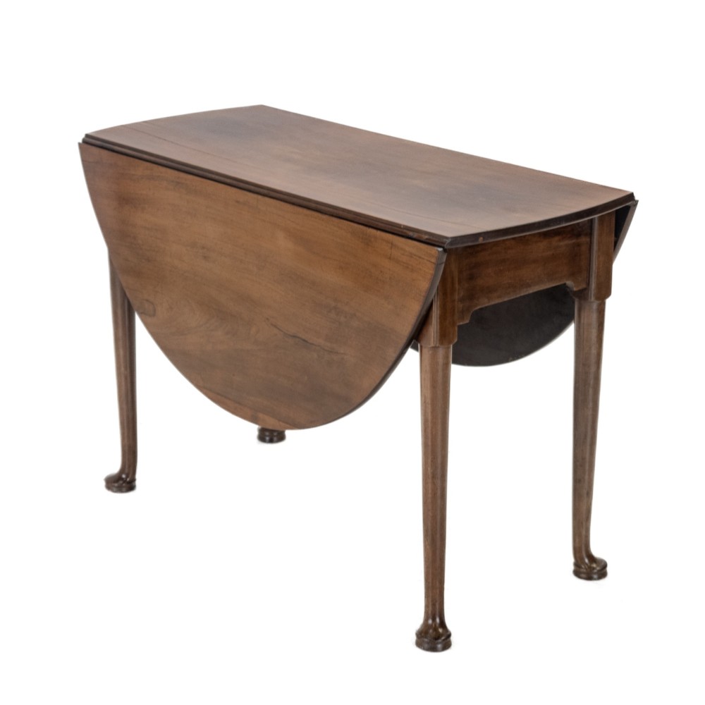 A George II mid-18th century dark mahogany oval drop-leaf table with slender legs ending in pad feet. View II