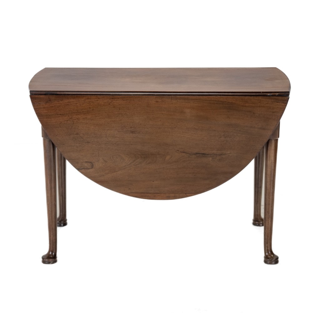 A George II mid-18th century dark mahogany oval drop-leaf table with slender legs ending in pad feet. View V
