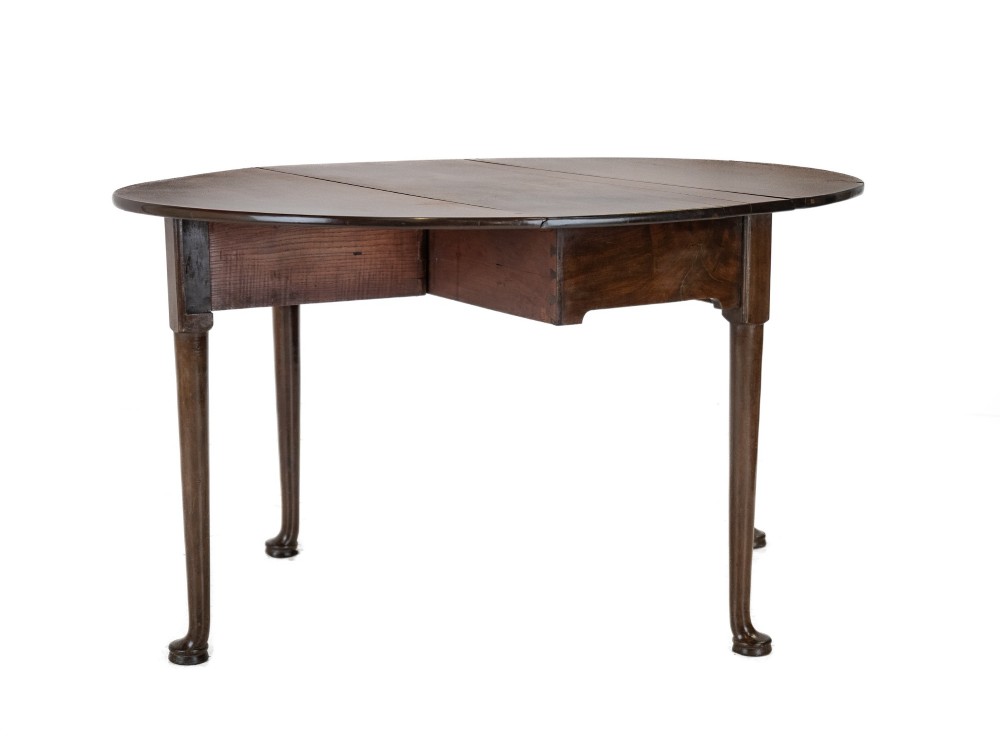 A George II mid-18th century dark mahogany oval drop-leaf table with slender legs ending in pad feet. View VII