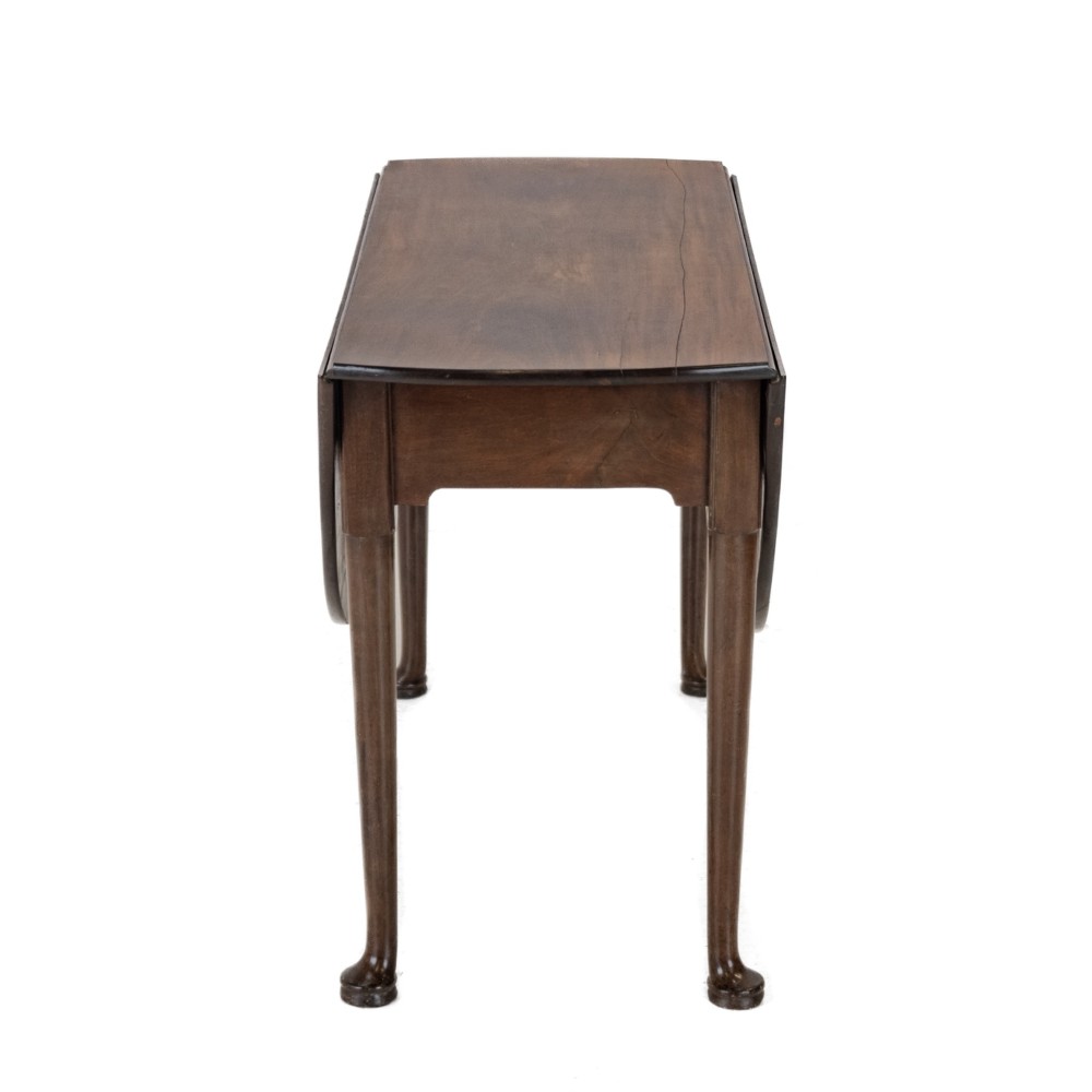 A George II mid-18th century dark mahogany oval drop-leaf table with slender legs ending in pad feet. View VIII