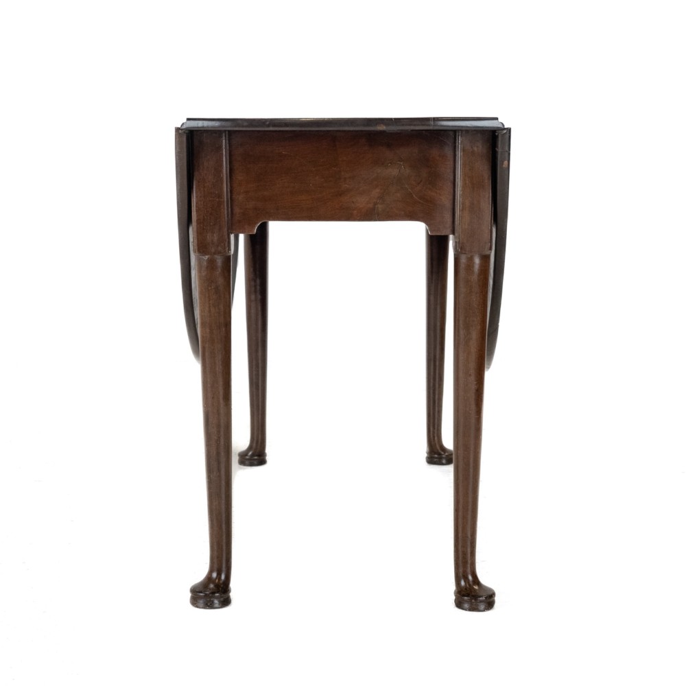 A George II mid-18th century dark mahogany oval drop-leaf table with slender legs ending in pad feet. View X