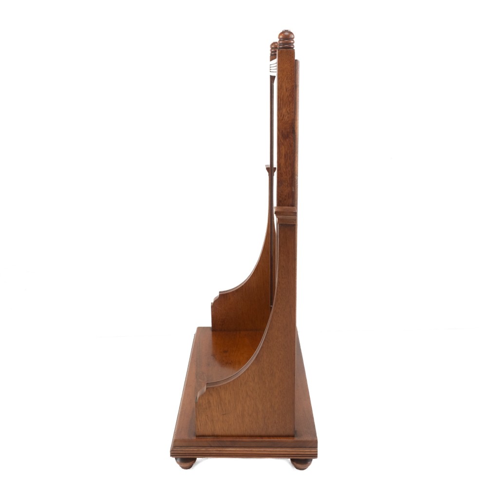 A late 19th-century mahogany table top dressing mirror featuring fluted upright columns, finials, a bevelled rectangular mirror plate, and a moulded wooden base on bun feet. View VIII