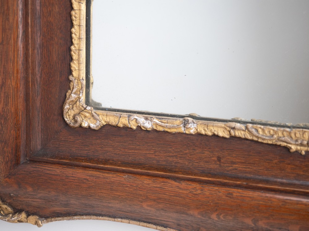 A rectangular dark oak wall mirror featuring a moulded timber frame with gilded gesso accents at the corners, outer edges, and inner sight edge. View XII