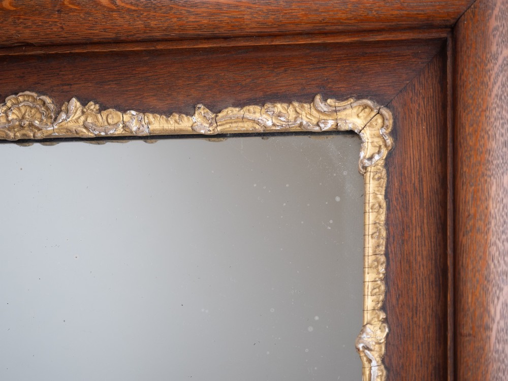 A rectangular dark oak wall mirror featuring a moulded timber frame with gilded gesso accents at the corners, outer edges, and inner sight edge. View XIII