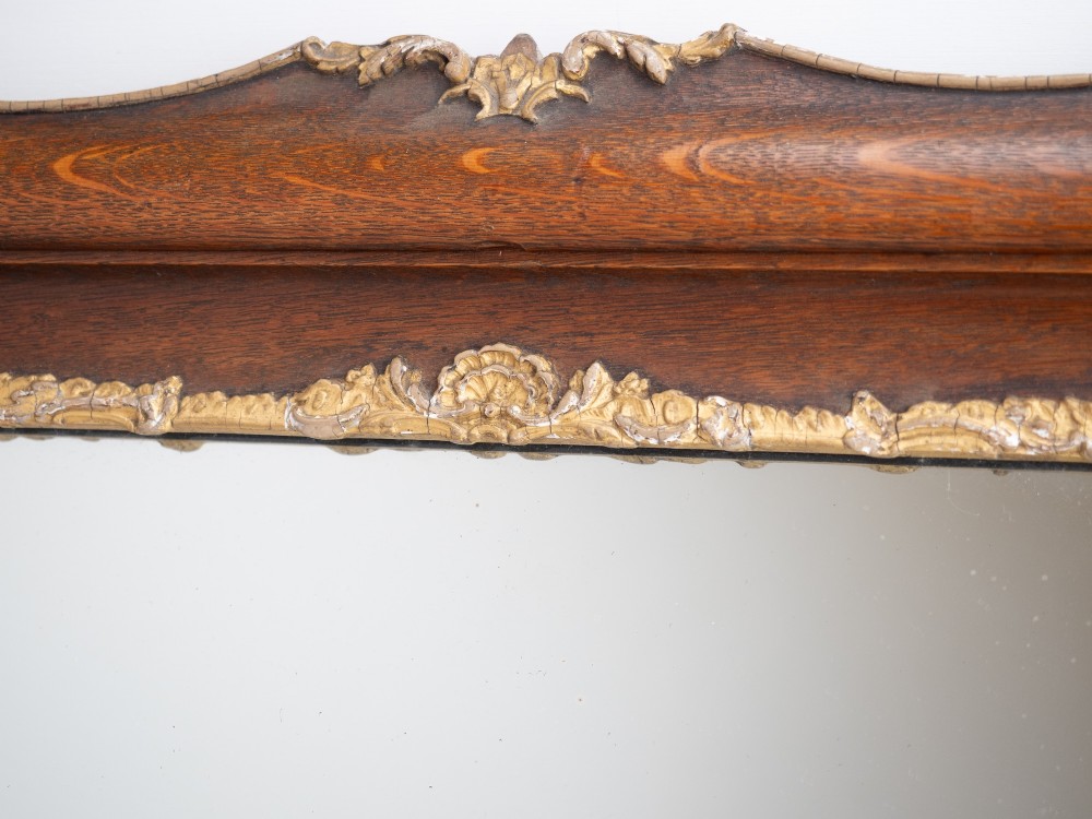 A rectangular dark oak wall mirror featuring a moulded timber frame with gilded gesso accents at the corners, outer edges, and inner sight edge. View XIV