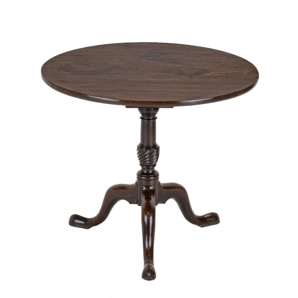 An 18th-century dark mahogany wine table with a round top, spiral-turned central column, and a tripod base with pad feet.