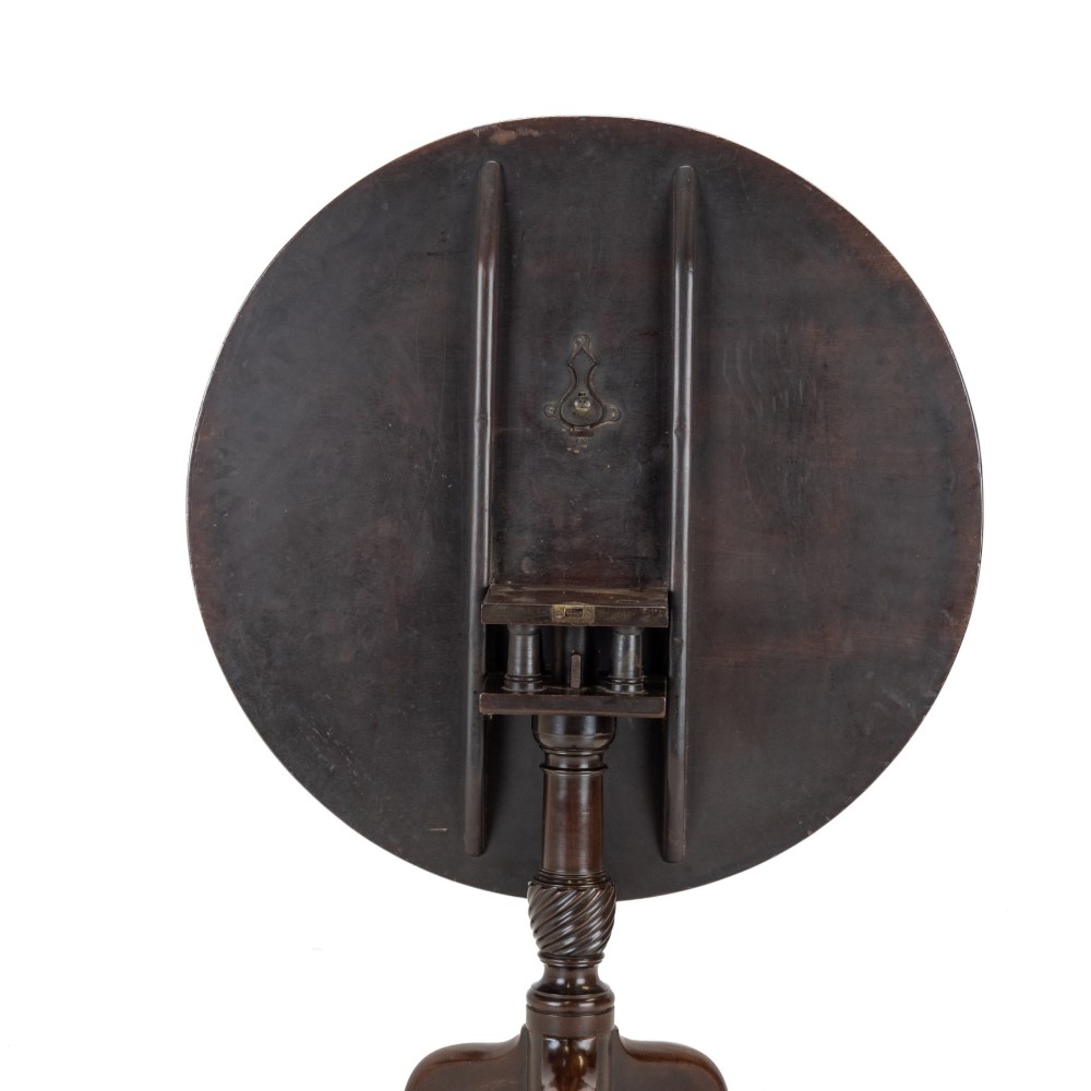 An 18th-century dark mahogany wine table with a round top, spiral-turned central column, and a tripod base with pad feet. View VI