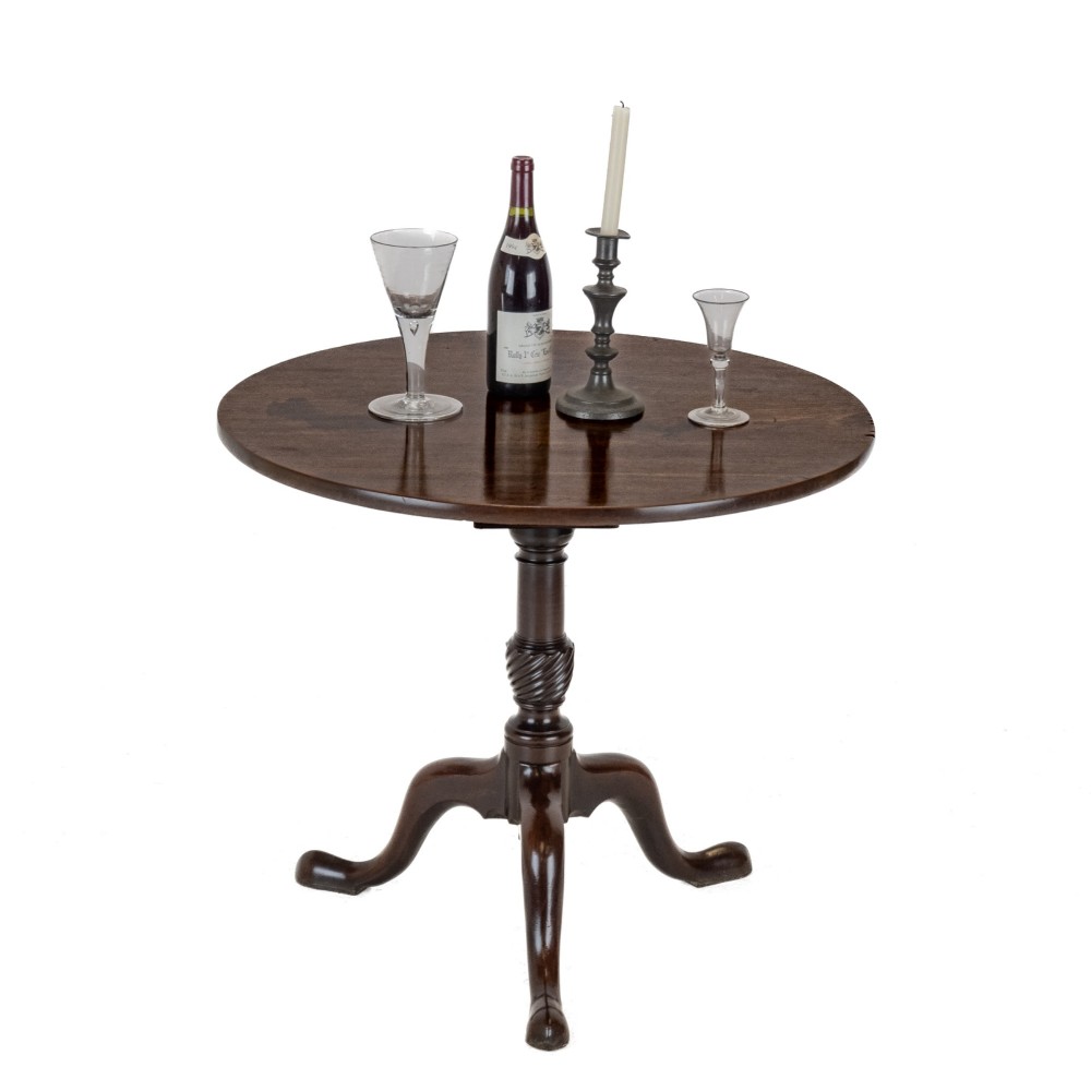 An 18th-century dark mahogany wine table with a round top, spiral-turned central column, and a tripod base with pad feet. View X