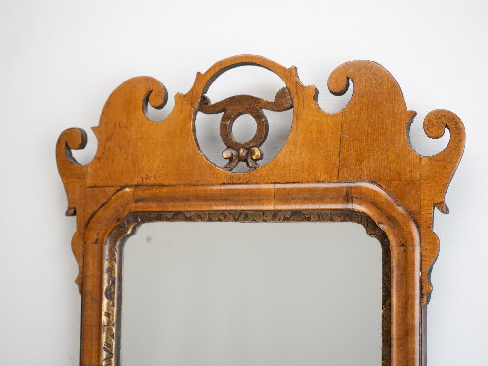 An 18th-century sycamore fretwork wall mirror featuring scrolled cresting with an openwork crest motif, a moulded rectangular frame, and an inner carved gilt slip. View III