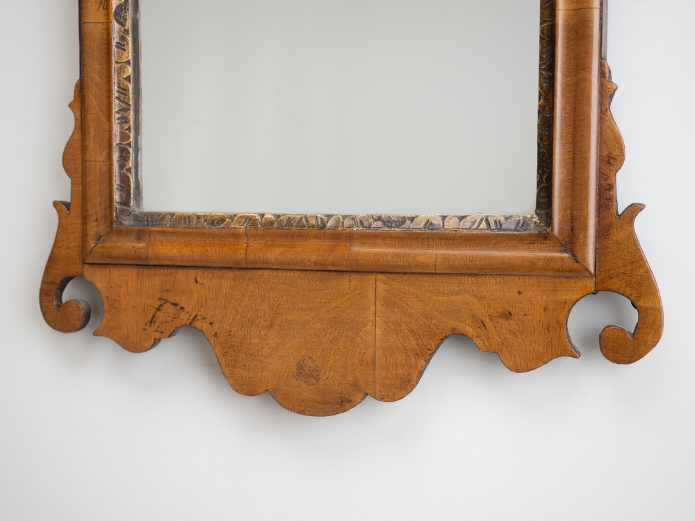 An 18th-century sycamore fretwork wall mirror featuring scrolled cresting with an openwork crest motif, a moulded rectangular frame, and an inner carved gilt slip. View VI