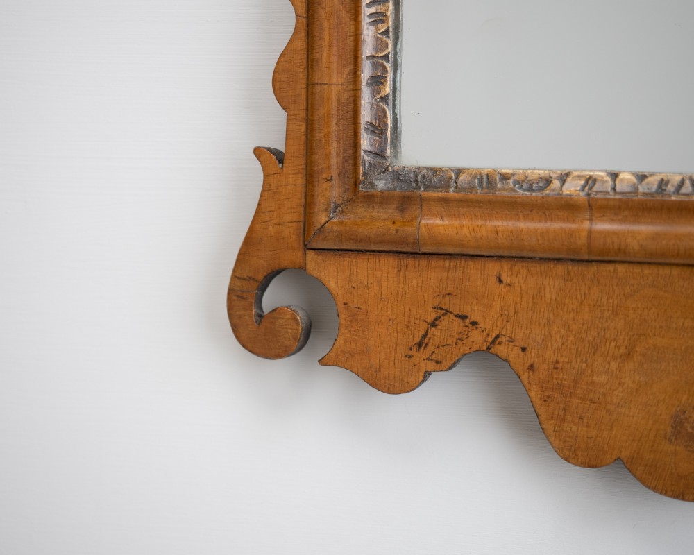 An 18th-century sycamore fretwork wall mirror featuring scrolled cresting with an openwork crest motif, a moulded rectangular frame, and an inner carved gilt slip. View VIII