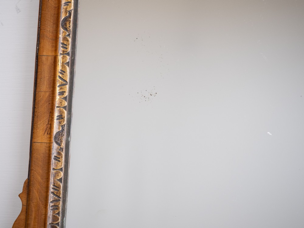 An 18th-century sycamore fretwork wall mirror featuring scrolled cresting with an openwork crest motif, a moulded rectangular frame, and an inner carved gilt slip. View IX