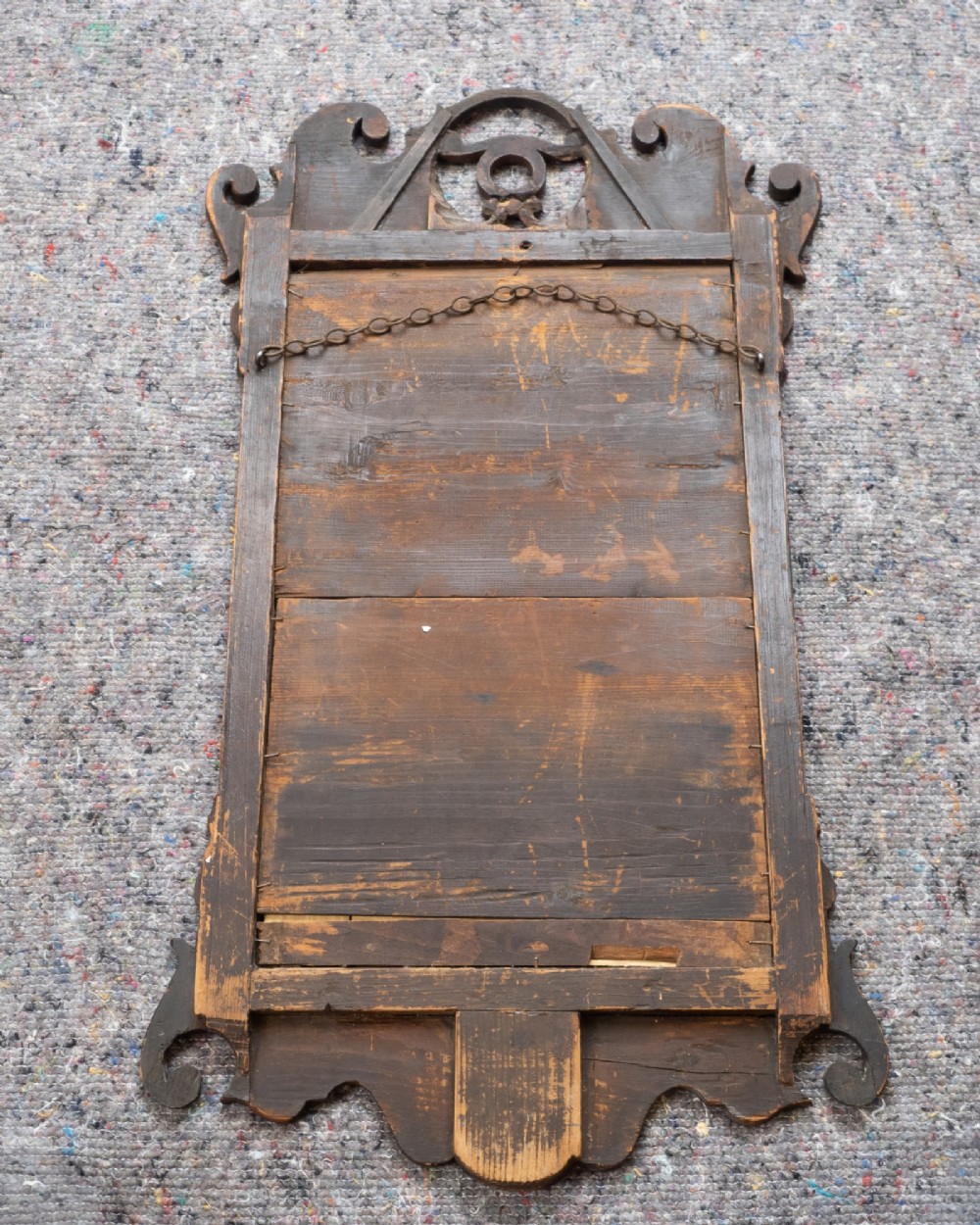 An 18th-century sycamore fretwork wall mirror featuring scrolled cresting with an openwork crest motif, a moulded rectangular frame, and an inner carved gilt slip. View XII