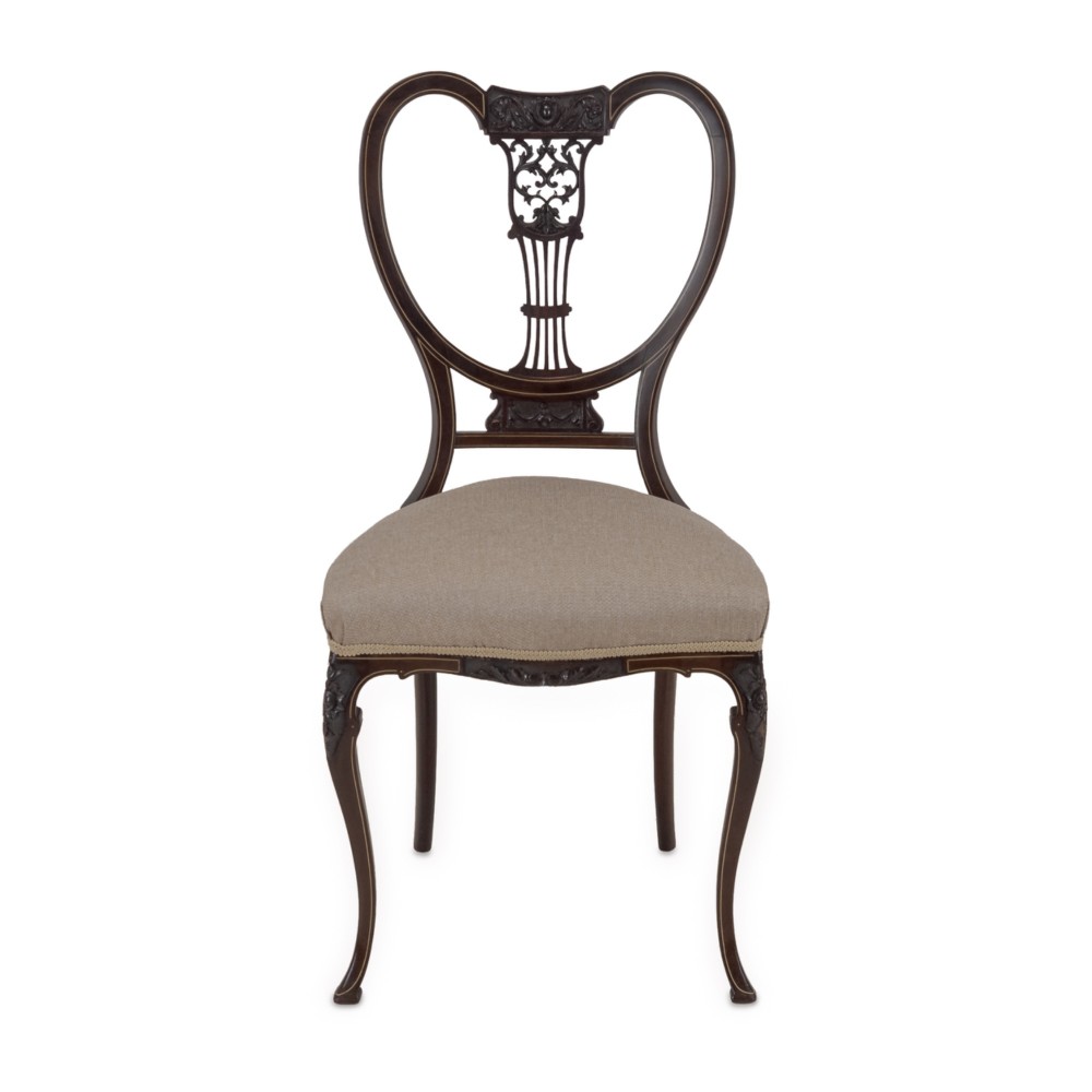A set of four Sheraton Revival mahogany salon chairs featuring openwork heart-shaped backs with intricate carved splats, neutral upholstered seats, and cabriole front legs. View X