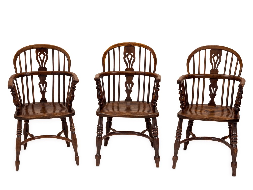 A set of six early 19th-century Windsor armchairs featuring hoop backs, pierced central splats, saddle seats, turned legs, and curved crinoline stretchers. View II