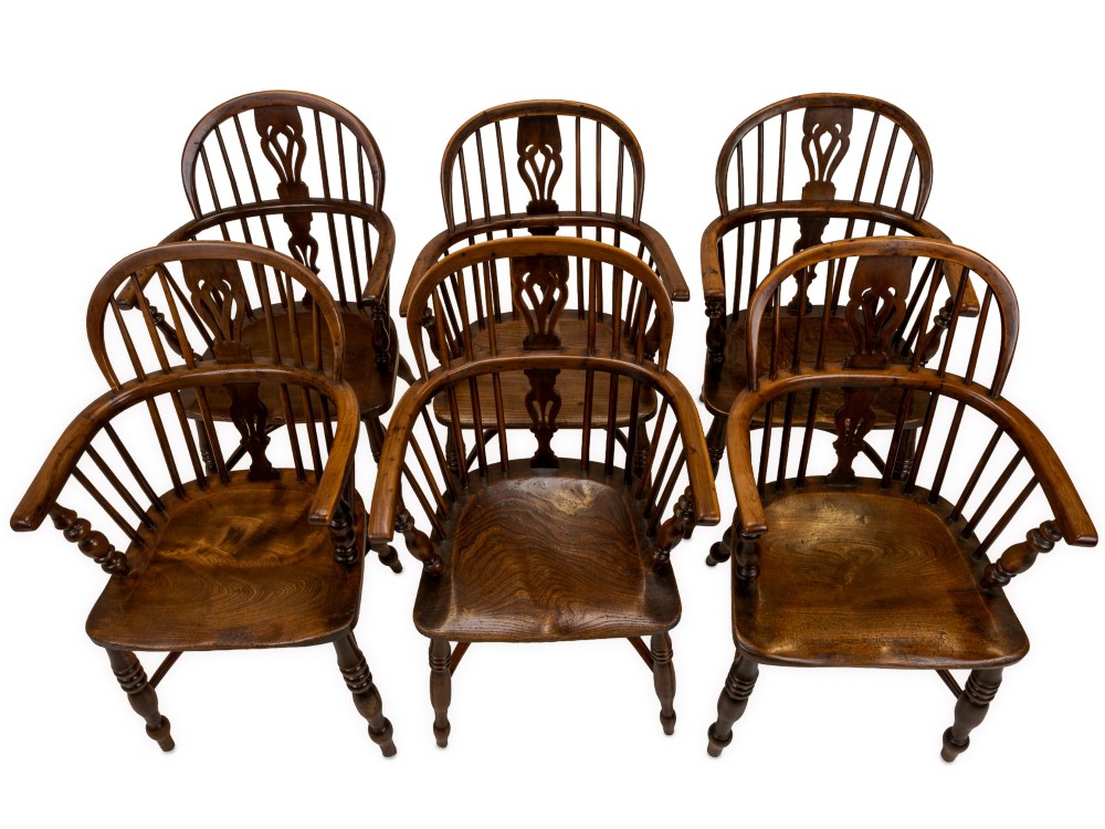 A set of six early 19th-century Windsor armchairs featuring hoop backs, pierced central splats, saddle seats, turned legs, and curved crinoline stretchers. View III