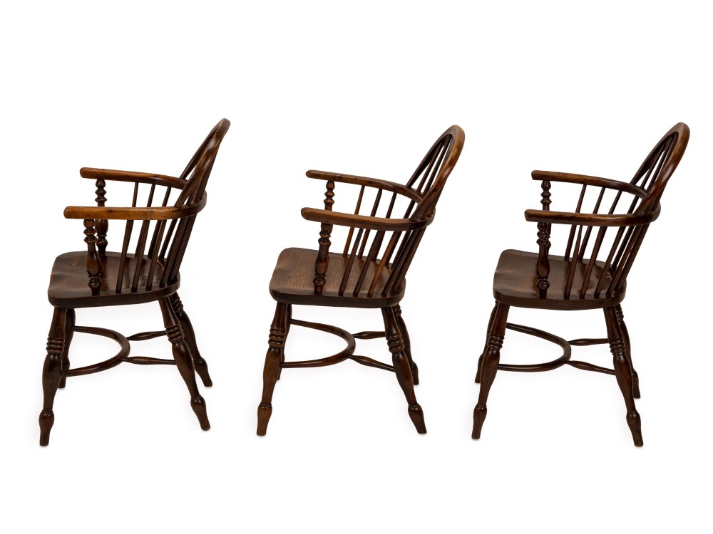 A set of six early 19th-century Windsor armchairs featuring hoop backs, pierced central splats, saddle seats, turned legs, and curved crinoline stretchers. View XII