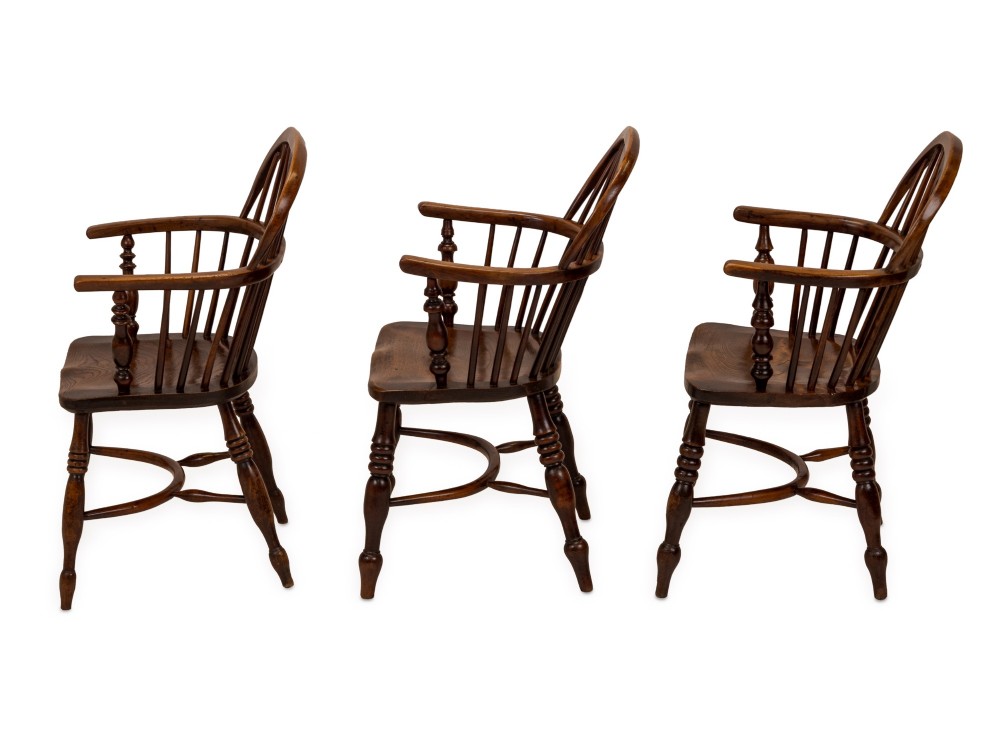 A set of six early 19th-century Windsor armchairs featuring hoop backs, pierced central splats, saddle seats, turned legs, and curved crinoline stretchers. View XIII