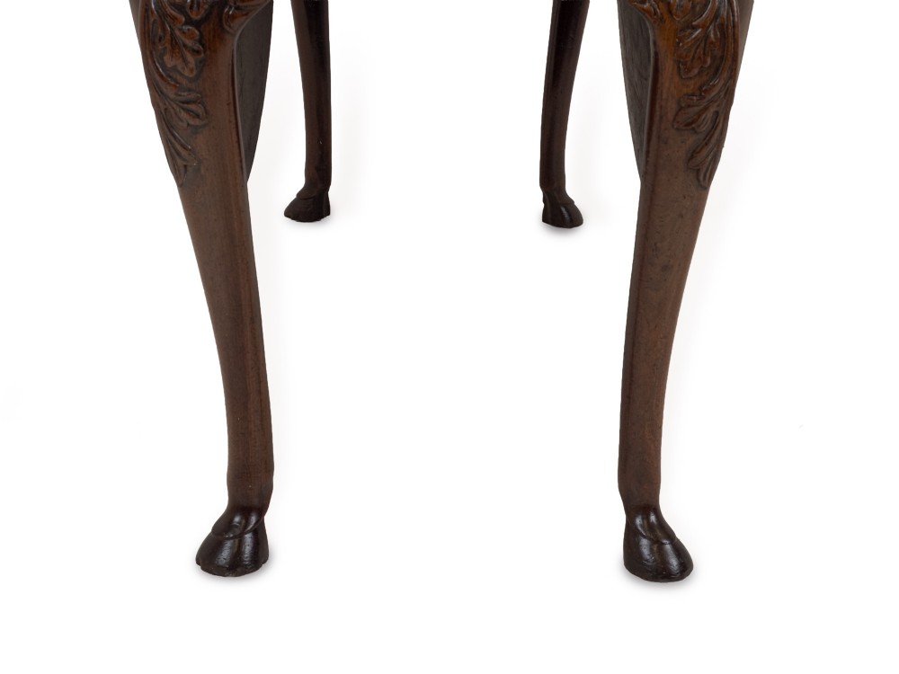 A George II Irish mahogany drop-leaf dining table with an oval top, end drawer, cabriole legs, and carved hoof feet. View XI