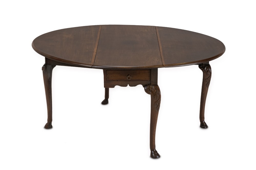 A George II Irish mahogany drop-leaf dining table with an oval top, end drawer, cabriole legs, and carved hoof feet. View XIII