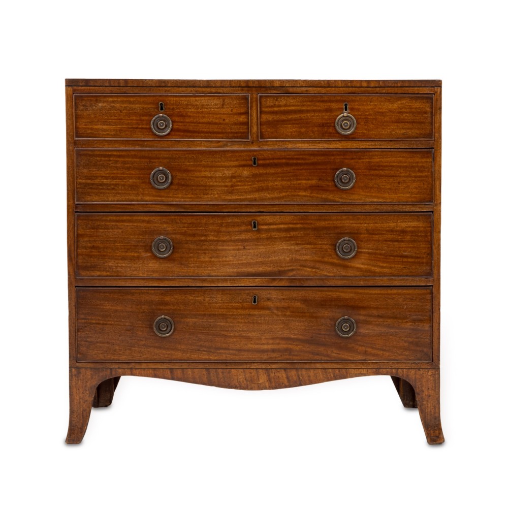 A late Georgian Regency mahogany chest of drawers featuring a caddy top, two short drawers over three long drawers, brass ring handles, and splayed bracket feet.