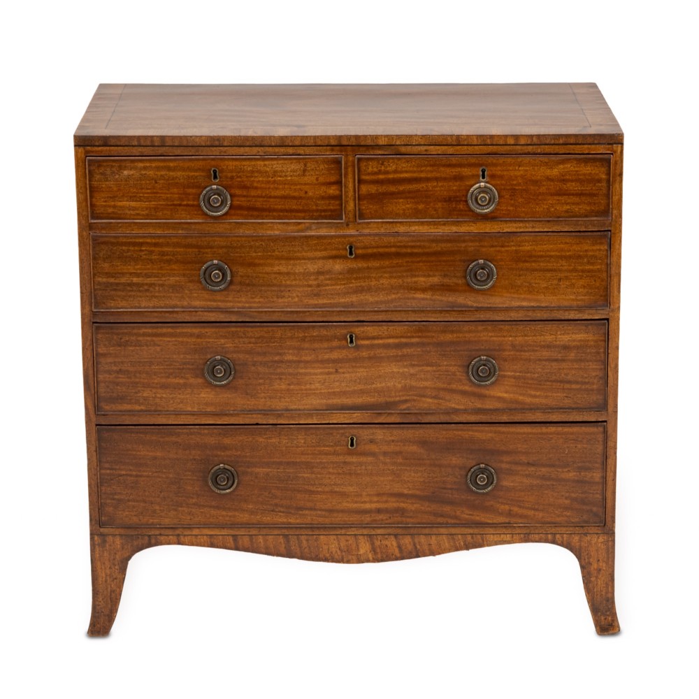 A late Georgian Regency mahogany chest of drawers featuring a caddy top, two short drawers over three long drawers, brass ring handles, and splayed bracket feet. View II
