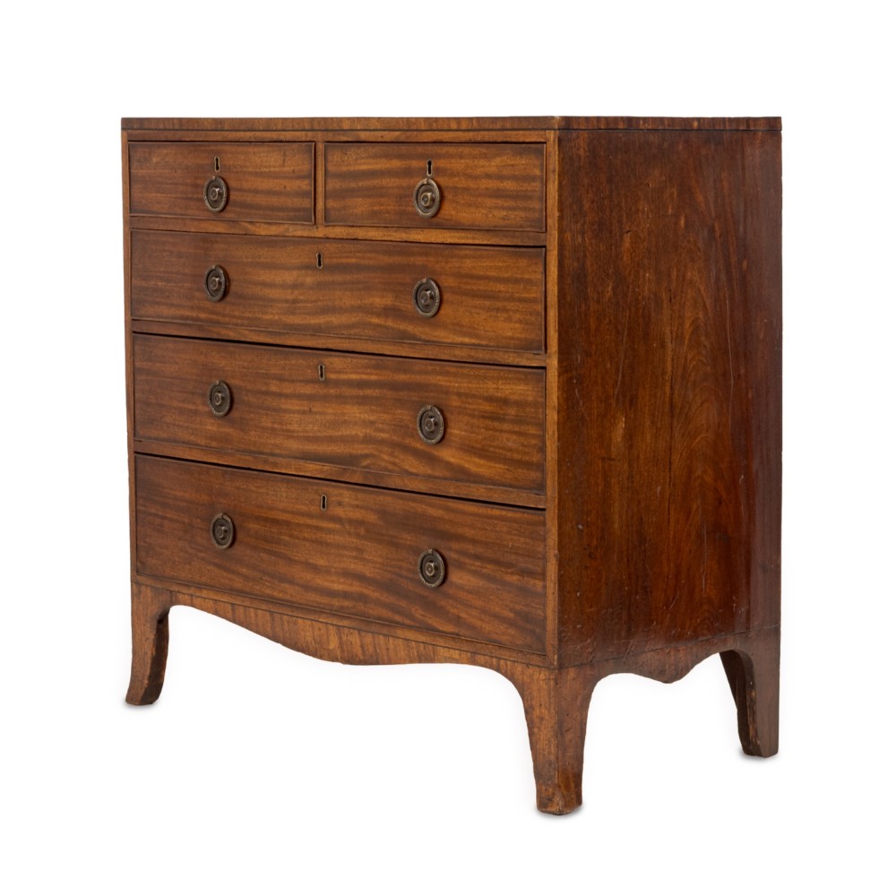 A late Georgian Regency mahogany chest of drawers featuring a caddy top, two short drawers over three long drawers, brass ring handles, and splayed bracket feet. View IV