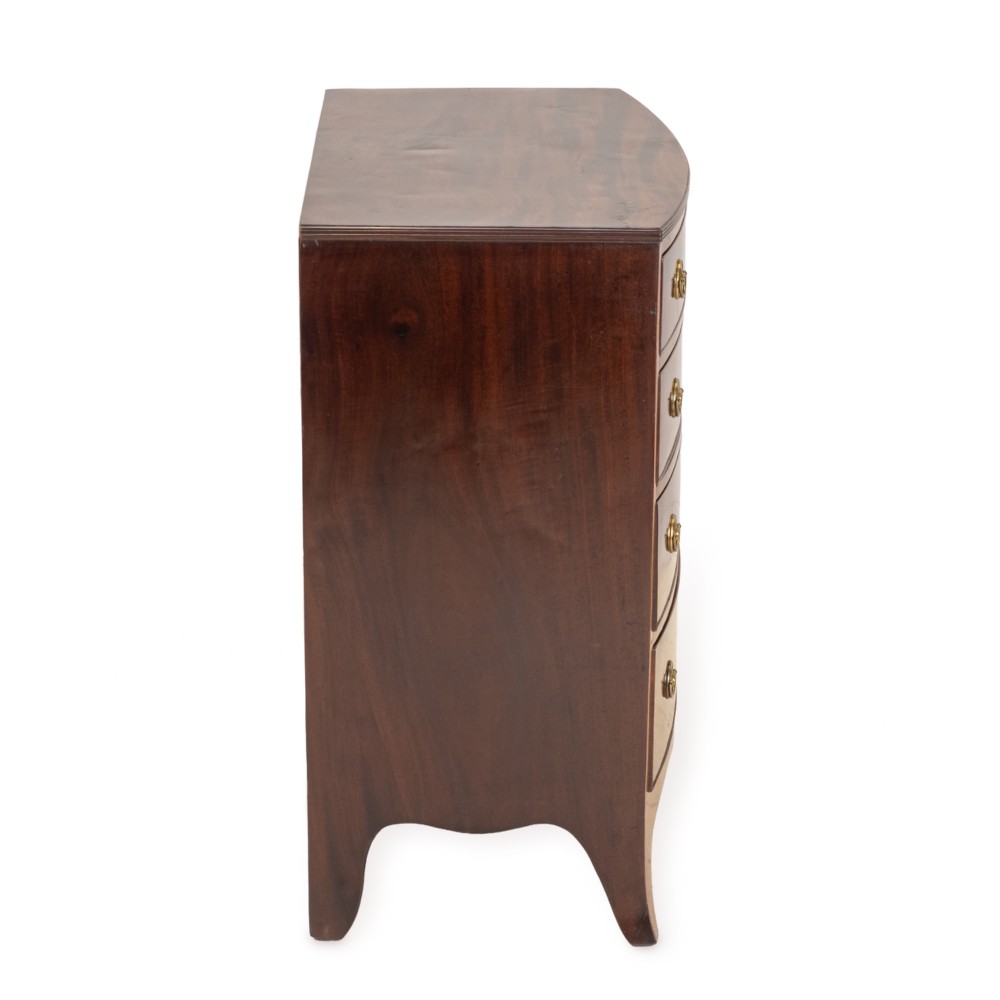 A Regency mahogany bow-front chest of drawers featuring four graduated drawers with circular brass ring handles and splayed bracket feet. View VIII