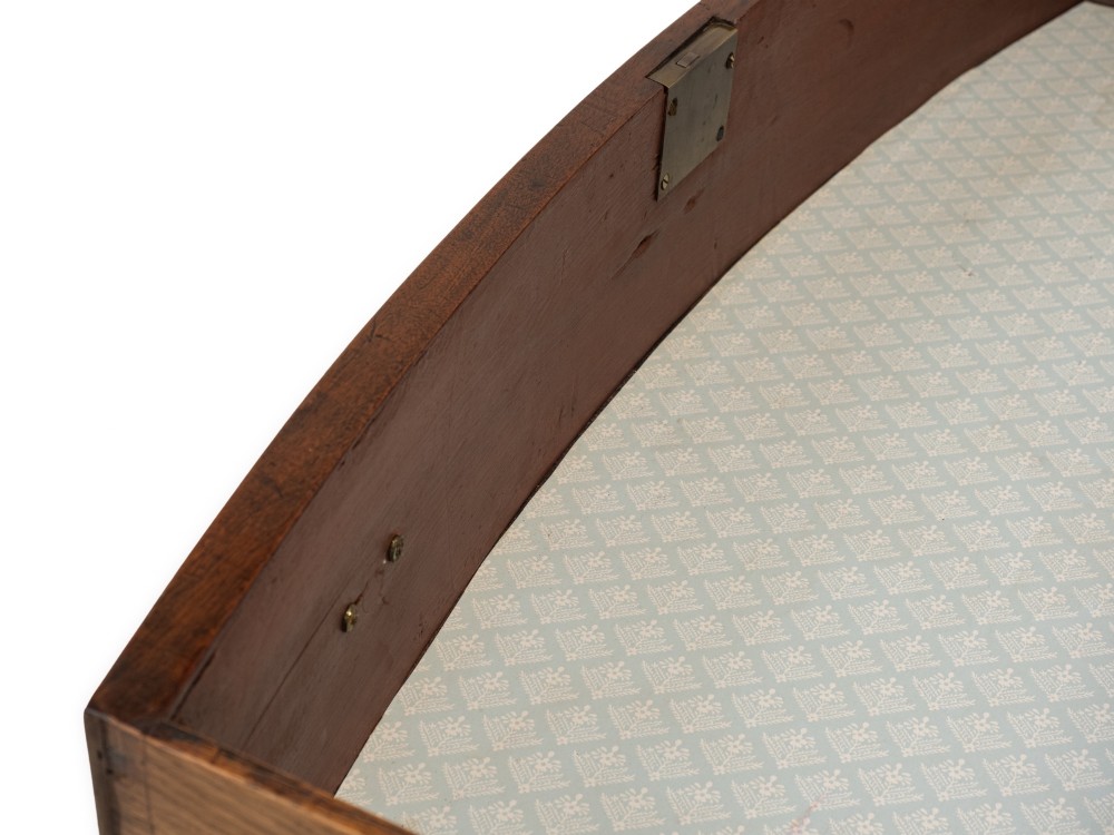 A Regency mahogany bow-front chest of drawers featuring four graduated drawers with circular brass ring handles and splayed bracket feet. View X