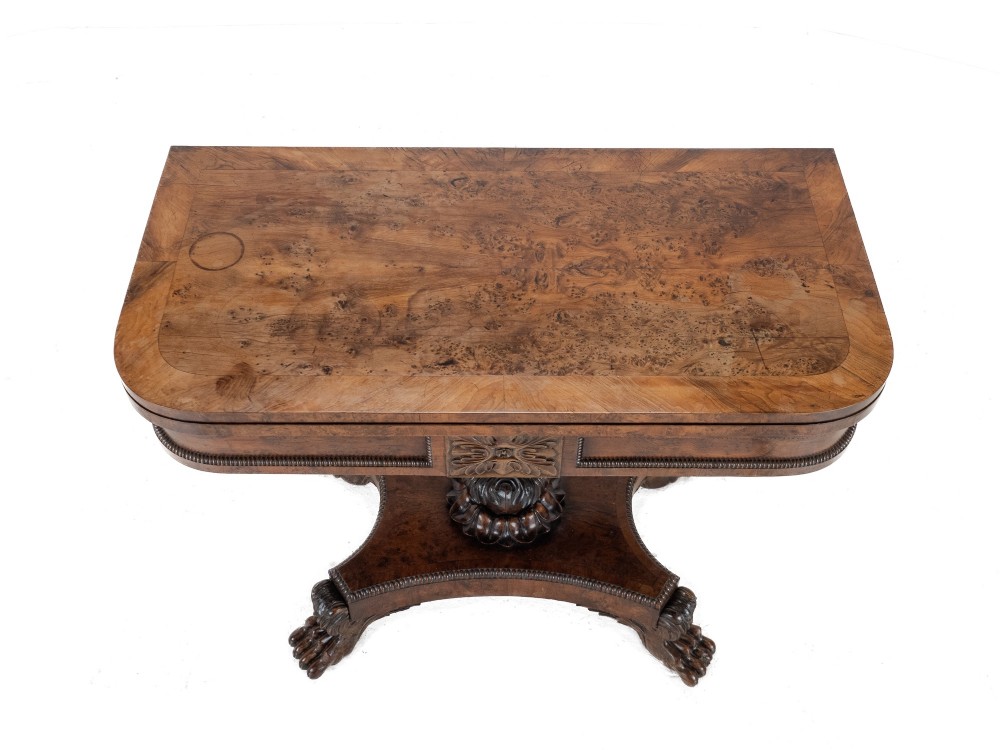 An antique William IV burr yew wood card table with a fold-over top, central carved pedestal column, and paw feet. View V