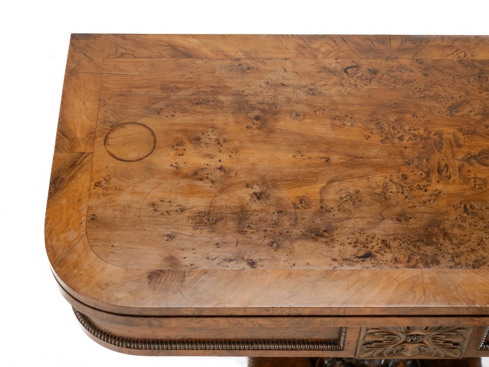 An antique William IV burr yew wood card table with a fold-over top, central carved pedestal column, and paw feet. View VI