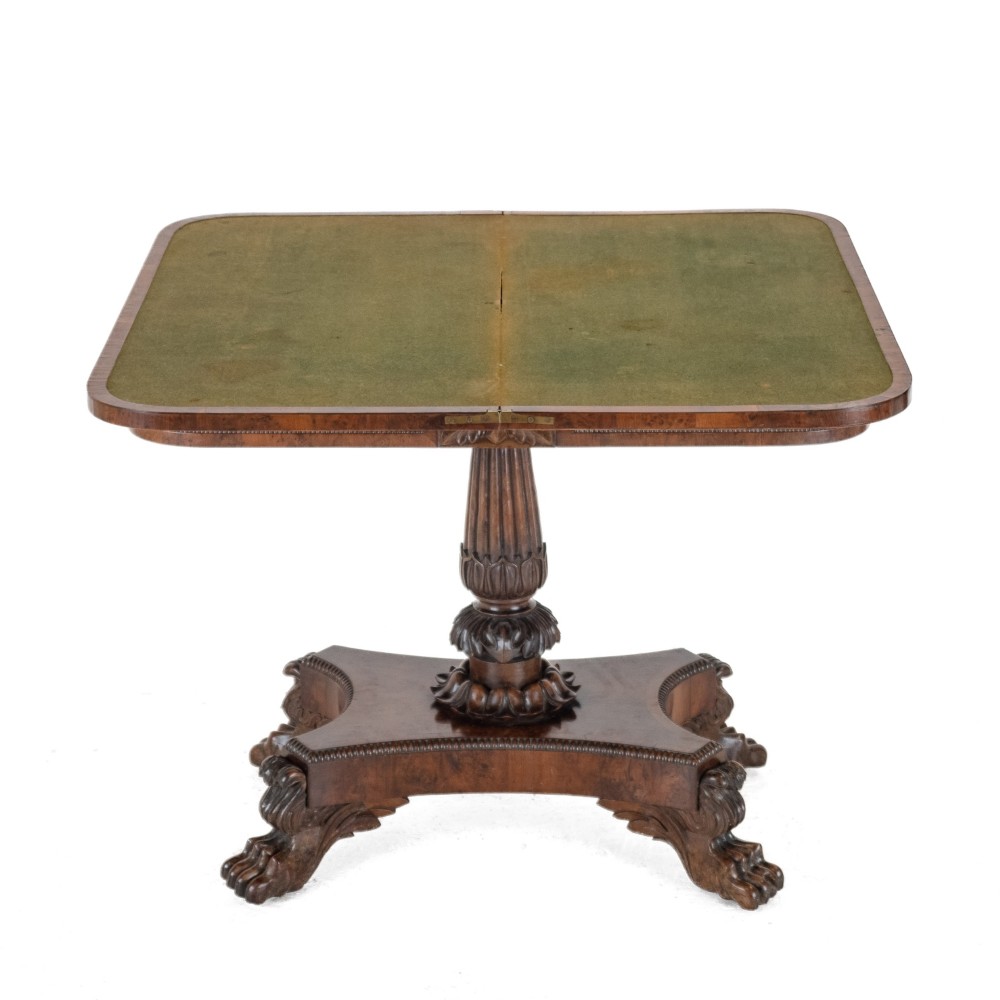An antique William IV burr yew wood card table with a fold-over top, central carved pedestal column, and paw feet. View VII