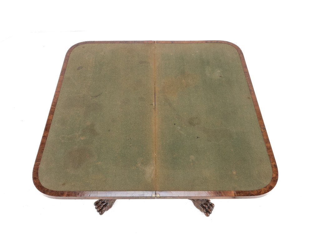 An antique William IV burr yew wood card table with a fold-over top, central carved pedestal column, and paw feet. View VIII