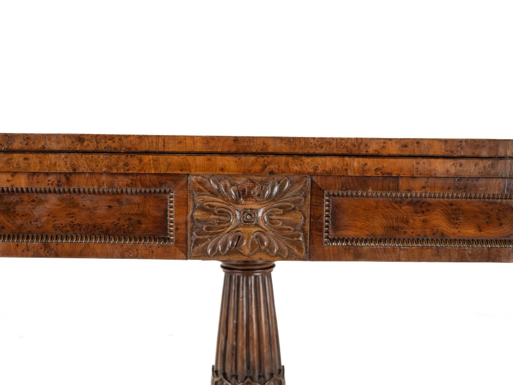 An antique William IV burr yew wood card table with a fold-over top, central carved pedestal column, and paw feet. View IX