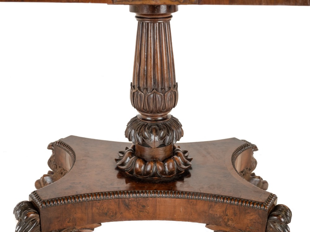 An antique William IV burr yew wood card table with a fold-over top, central carved pedestal column, and paw feet. View X