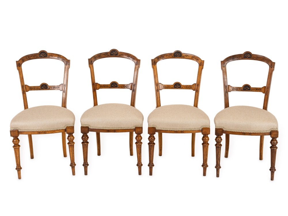 A set of four antique Regency satin birch dining chairs featuring carved crest rails, turned front legs, and neutral fabric upholstered seats. View IV