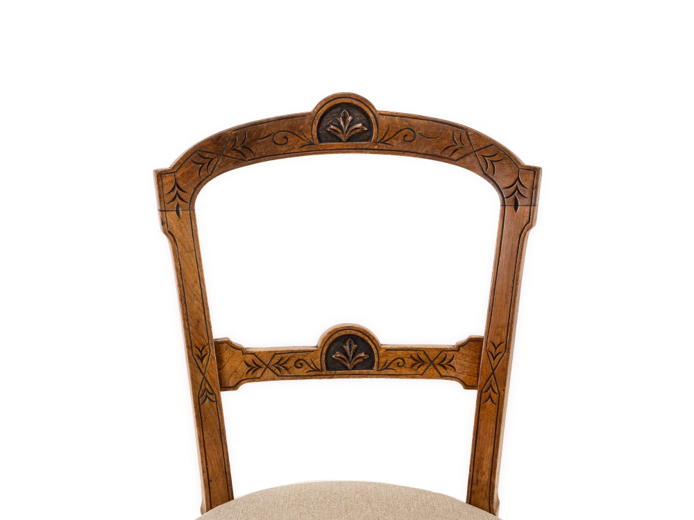 A set of four antique Regency satin birch dining chairs featuring carved crest rails, turned front legs, and neutral fabric upholstered seats. View VI