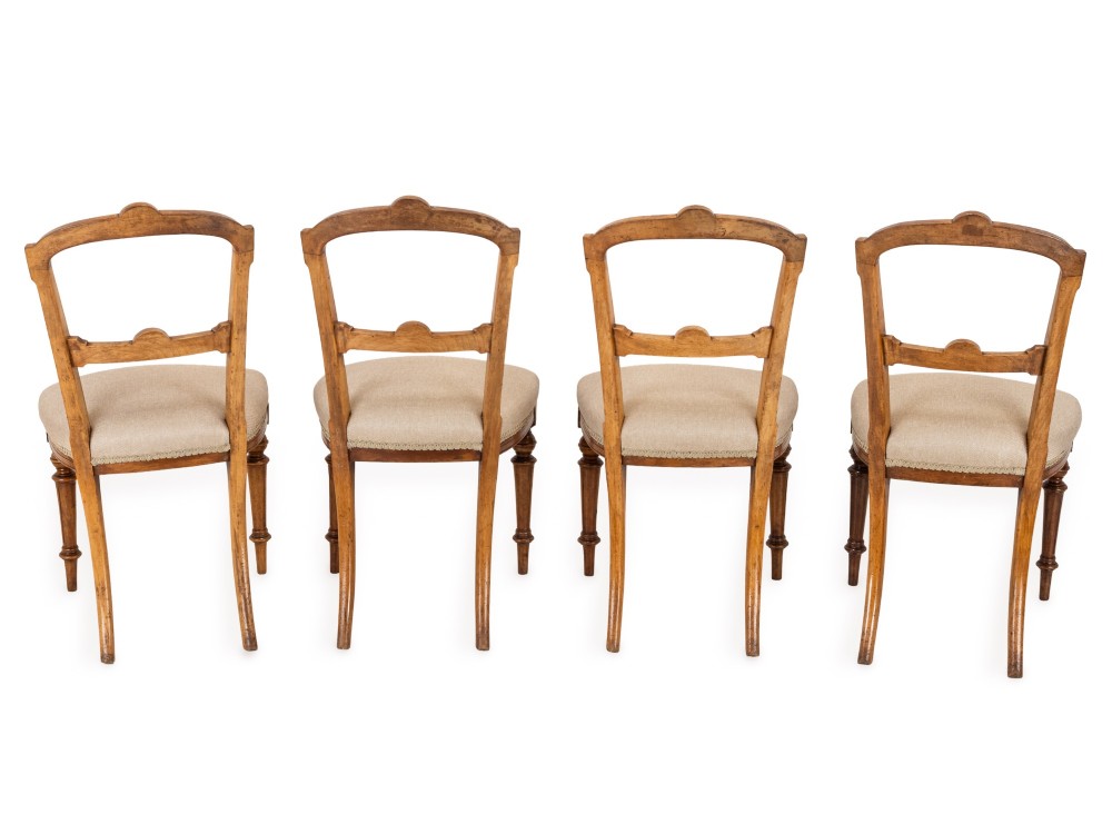 A set of four antique Regency satin birch dining chairs featuring carved crest rails, turned front legs, and neutral fabric upholstered seats. View XI