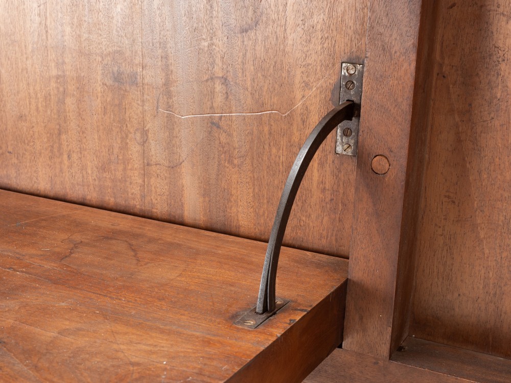 A George III mahogany dining table featuring a rectangular tilt-top surface with rounded corners set on a reeded central pedestal and four splayed legs with brass paw castors. View XII